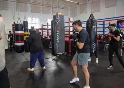 Two people in a gym with boxing bags