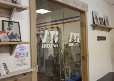 A gym with boxing equipment on the wall.