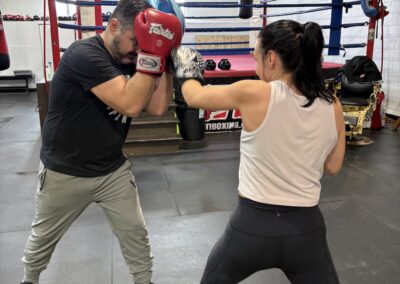 A man and woman boxing in the ring.